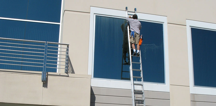 Paul Black cleaning a 2nd story window of a commercial building in Rocklin, CA.